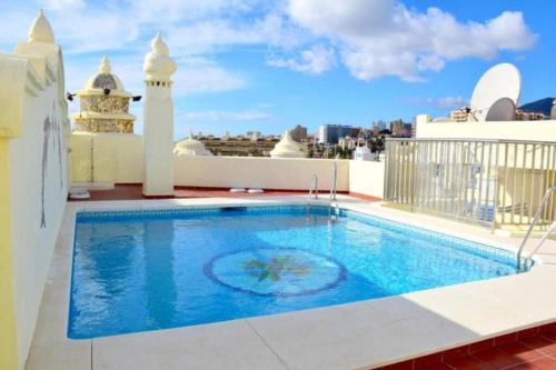 a swimming pool on the roof of a building at Simply Astonishing Location in Benalmádena