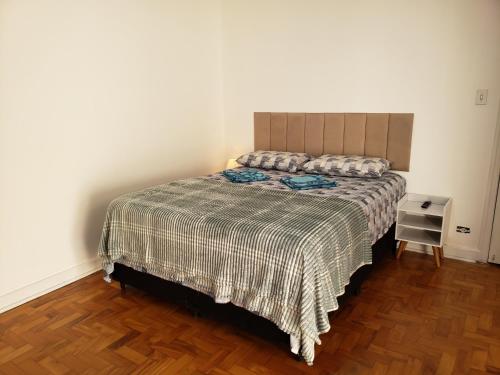 a bedroom with a bed and a wooden floor at Pousada Monte Gerizim in Sao Paulo