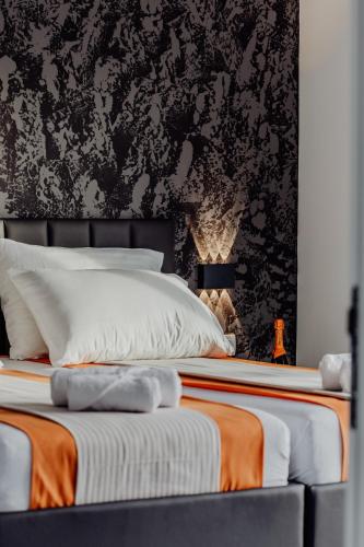 two beds in a bedroom with black and white wallpaper at BRAND NEW! Villa Adriatic Bay2 with a private pool in Novalja