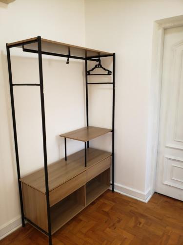 a black book shelf in a room with wooden floors at Pousada Monte Gerizim in Sao Paulo