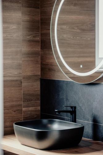 a bathroom with a black sink and a mirror at BRAND NEW! Villa Adriatic Bay2 with a private pool in Novalja
