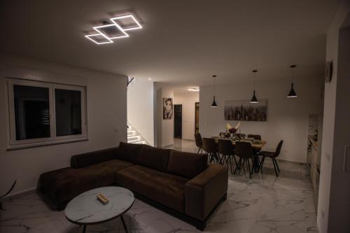 a living room with a couch and a table at BRAND NEW! Villa Adriatic Bay2 with a private pool in Novalja