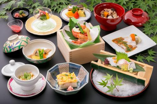 a table topped with different types of food in boxes at Iwakuni Kokusai Kanko Hotel in Iwakuni