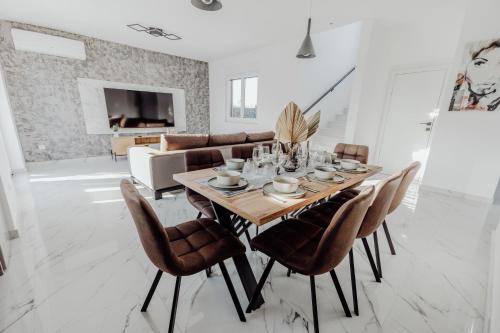 a dining room with a table and chairs at BRAND NEW! Villa Adriatic Bay2 with a private pool in Novalja
