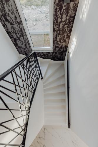 a staircase in a house with a window at BRAND NEW! Villa Adriatic Bay2 with a private pool in Novalja