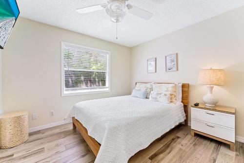 a bedroom with a bed and a window at Living the Dream By Beachside Management in Siesta Key