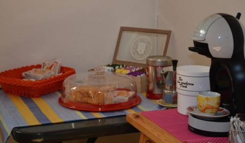 a kitchen counter with a table with a blender and food at App. Valentina in Segonzano