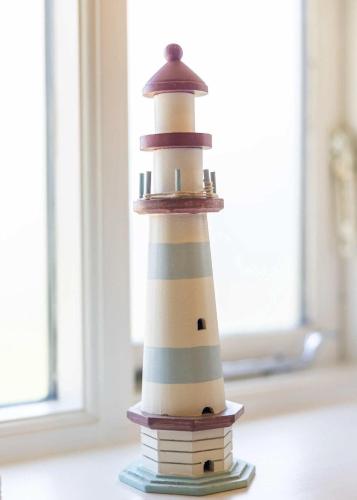 a lighthouse toy sitting on top of some books at Coast Barn, Noss Mayo, Plymouth in Plymouth