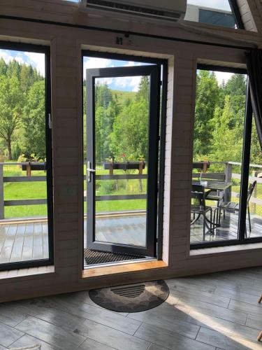 a screened in porch with sliding glass doors at Soul House in Pilipets