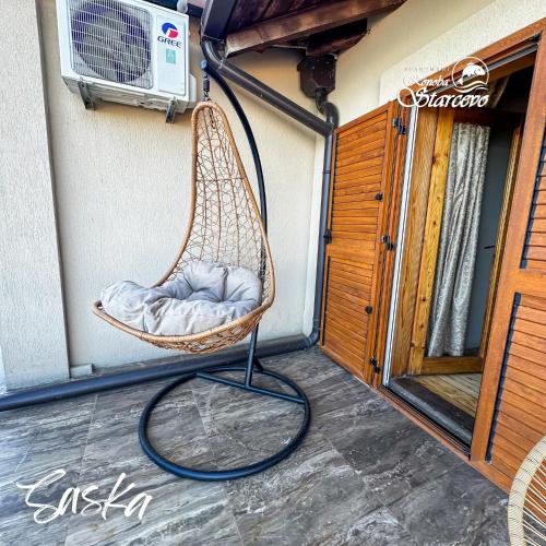 a hammock hanging on the side of a building at Apartmani Konoba Starčevo in Virpazar