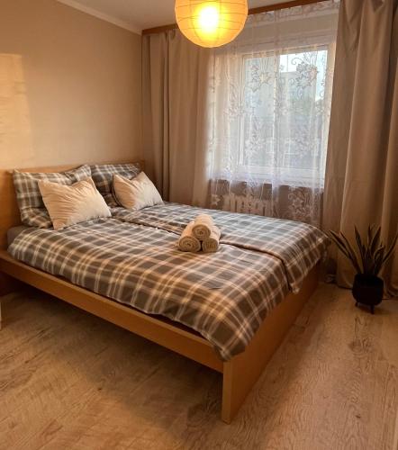 a bedroom with a bed with two towels on it at Apartament Zavodzie in Katowice