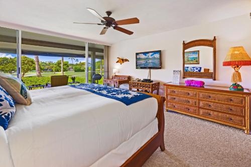 a bedroom with a bed and a dresser and a mirror at Maui Eldorado - G108 - Stay in the Heart of Kaanapali in Kahana
