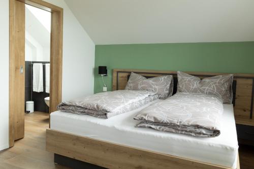 a bed with two pillows on it in a room at Gasthof Sternen Detligen in Detligen