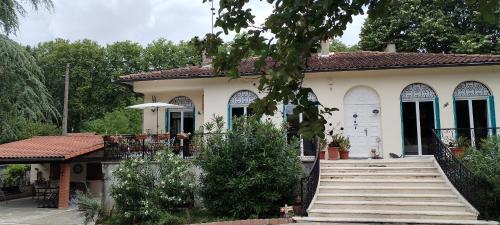 a house with a staircase in front of it at La Casanat in Montgiscard