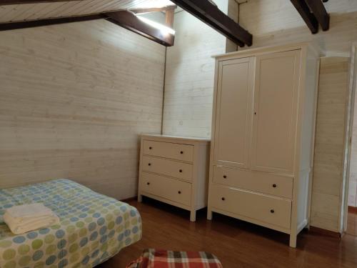 a bedroom with a bed and a dresser at Dorė in Nida