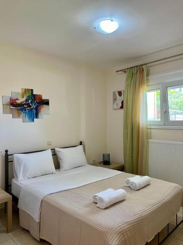 a bedroom with a bed with two towels on it at Aspasia Apartment in Kanali