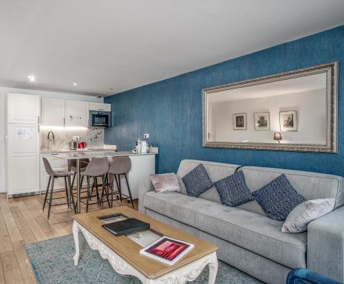 un salon avec un canapé et une table dans l'établissement Apartments Du Louvre St Honoré, à Paris