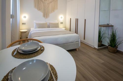 a hotel room with two beds and a table at Cerro Fine Living in Ermoupoli