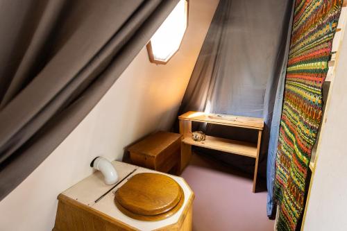 a small room with a toilet and a telephone at Centre de l'Hêtre in Lac-Beauport