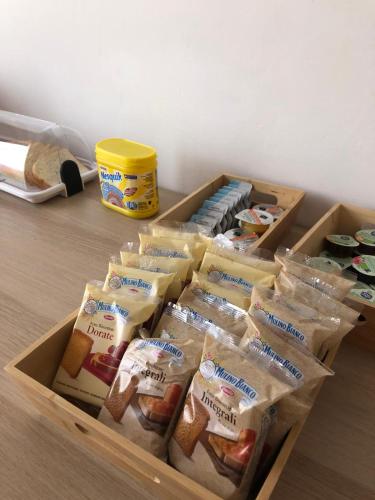 a box of cheese and other food items on a table at B&B Stella marina in Porto Recanati