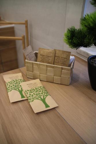 two cards on a table with a basket with a tree on it at Frida Luxury B&B in Vietri sul Mare