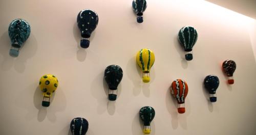 a group of toy cars on display on a wall at Frida Luxury B&B in Vietri sul Mare