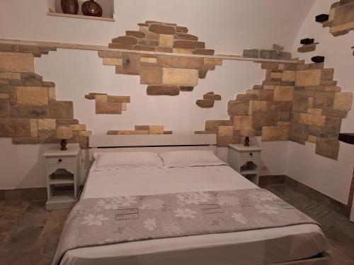 a bedroom with a bed and two night stands at La Cantina di Alba & Tramonto in Pimonte