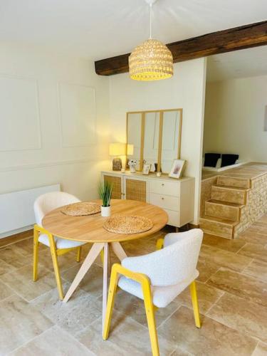 une salle à manger avec une table et des chaises en bois dans l'établissement Le Cocon, à Braux