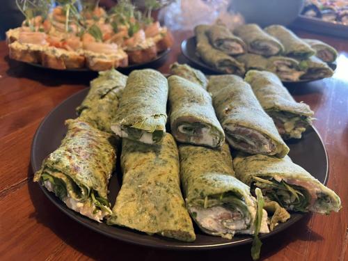 a plate of food on a table with sandwiches at Villa Heaven Green in Pazin