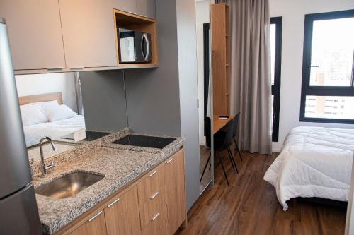 a kitchen with a sink and a bed in a room at ST Studios Vila Mariana by Housi in Sao Paulo