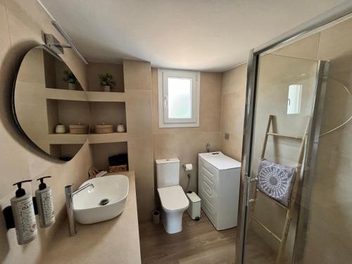 a bathroom with a sink toilet and a mirror at Cerro Fine Living in Ermoupoli