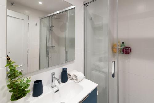a bathroom with a sink and a shower with a mirror at Albada Huesca in Huesca
