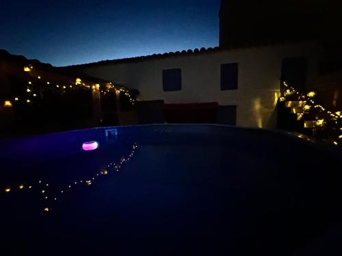 a night view of a swimming pool in a house at Casa Rural al Sol De Las Ruinas- piscina privada in Belchite