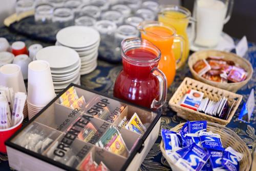 a table topped with plates and bowls of food at Hotel Vico Alto Siena in Siena