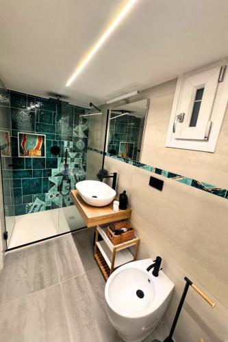 a bathroom with a toilet and a sink and a shower at Frida Luxury B&B in Vietri sul Mare