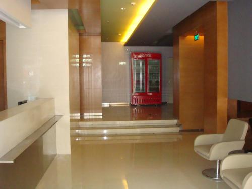 a red telephone booth in a room with chairs at Jinjiang Inn Lianyungang South Nanji Road in Lianyungang