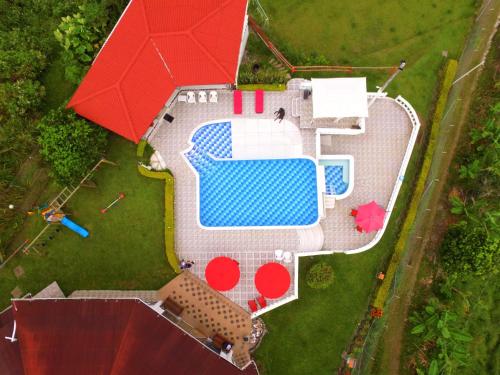 an overhead view of a swimming pool with a red umbrella at Castillo Del Toro in Armenia