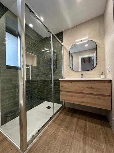 a bathroom with a shower and a mirror at Aire de Picos Norte in Brez