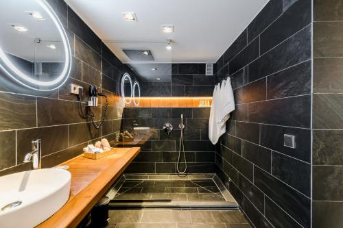 a bathroom with a sink and a shower at Hotel Boutique Ses Pitreras in San Antonio Bay