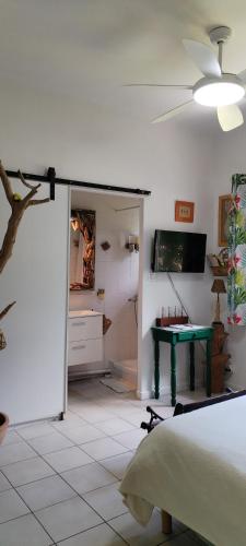 a bedroom with a bed and a green table at La Casanat in Montgiscard