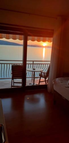 a room with a window with a view of the ocean at Apartment Bellavita Senj in Senj