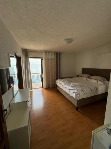 a bedroom with a large bed and a balcony at Apartment Bellavita Senj in Senj