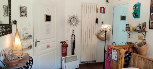 a room with a white door and a lamp at La Casanat in Montgiscard