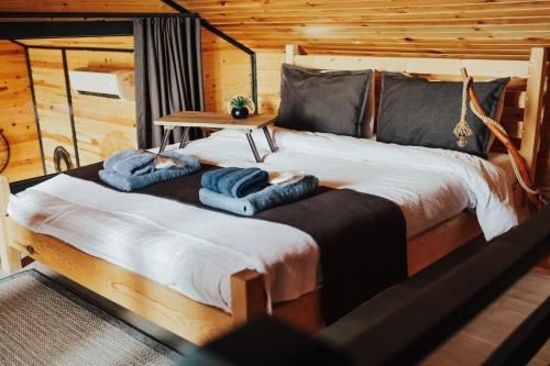 a bedroom with a large bed with towels on it at LakeviewhouseSapanca in Sapanca