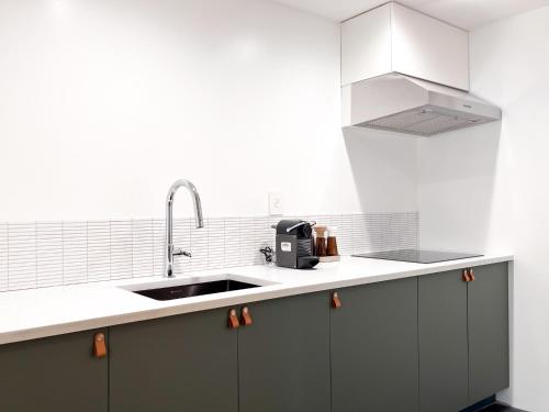 a kitchen with a sink and a counter top at Exquisite and Modern Stay in Brooklyn at Rem-Casa in Brooklyn