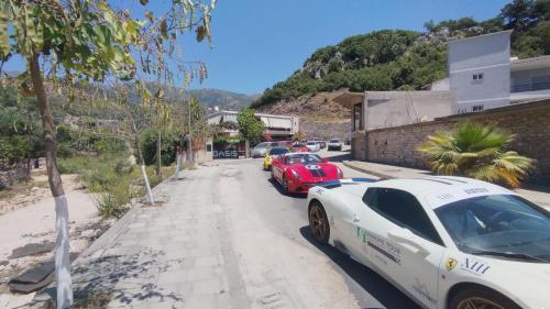 two cars parked on the side of a street at Oasis Hostel in Himare
