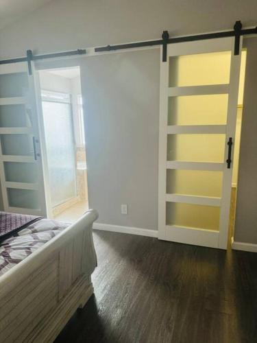 a bedroom with a sliding glass door with a bed at Paradise in Las Vegas