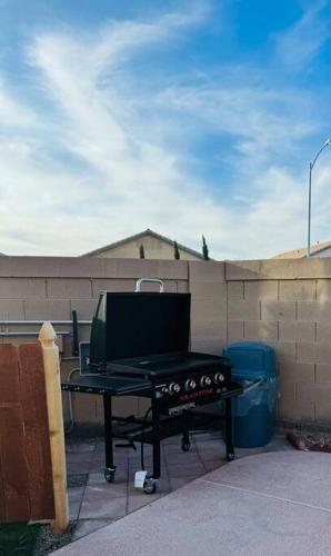 a barbecue grill on a table in front of a fence at Paradise in Las Vegas