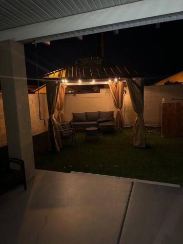 a patio at night with a couch and a table at Paradise in Las Vegas