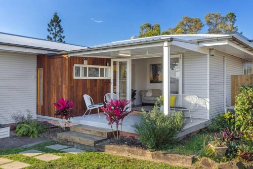 a house with a porch with a table and chairs at Warm and Cozy Cottage House in Gympie
